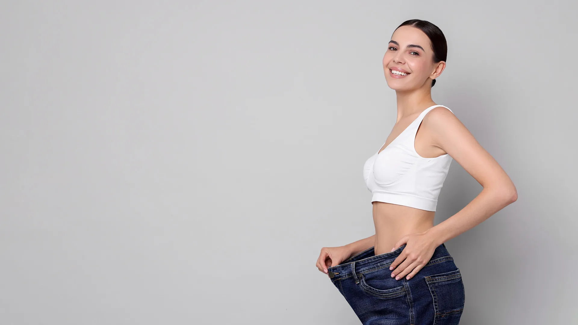 Woman celebrating weight loss results at iCRYO Branford Medical Weight Loss program